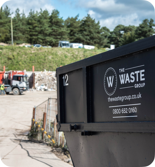 a black skip with a waste group logo