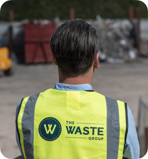 man wearing a vest with a waste group logo on the back