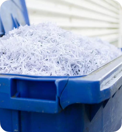 a blue wheelie bin full of shredded paper