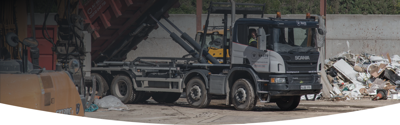 a waste group skip lorry unloading