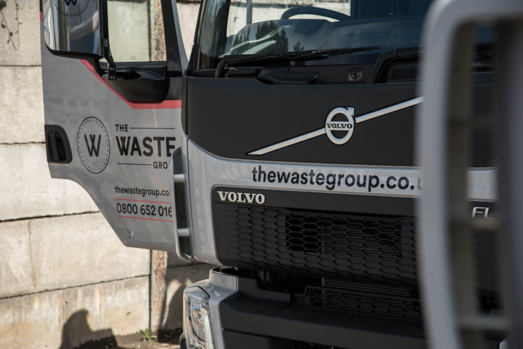 a truck with the waste group logo