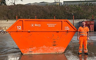 12-yard container, man standing next to it
