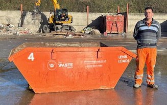 4-yard container, man standing next to it