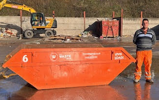6-yard container, man standing next to it
