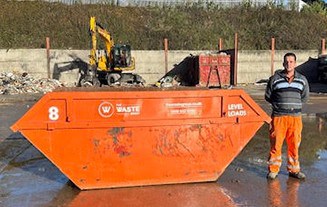 8-yard container, man standing next to it