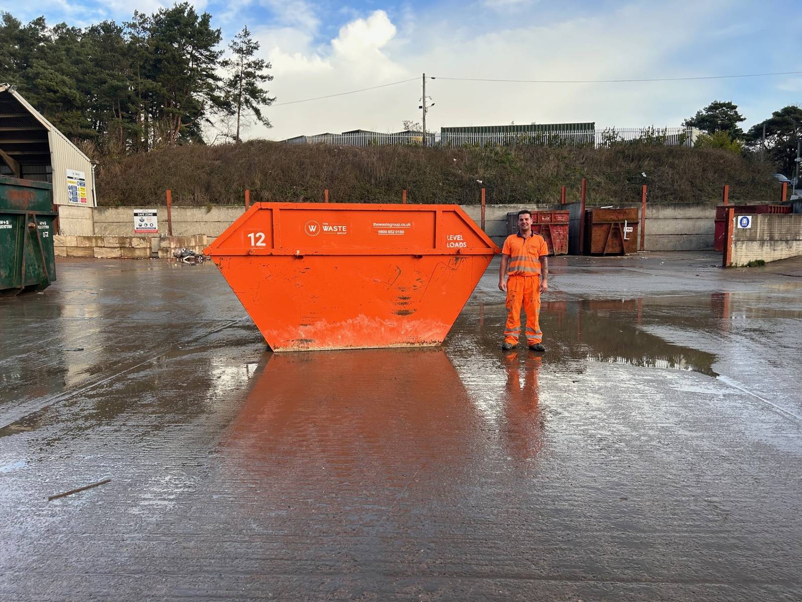 12 yard skip with a person standing beside it for scale at The Waste Group