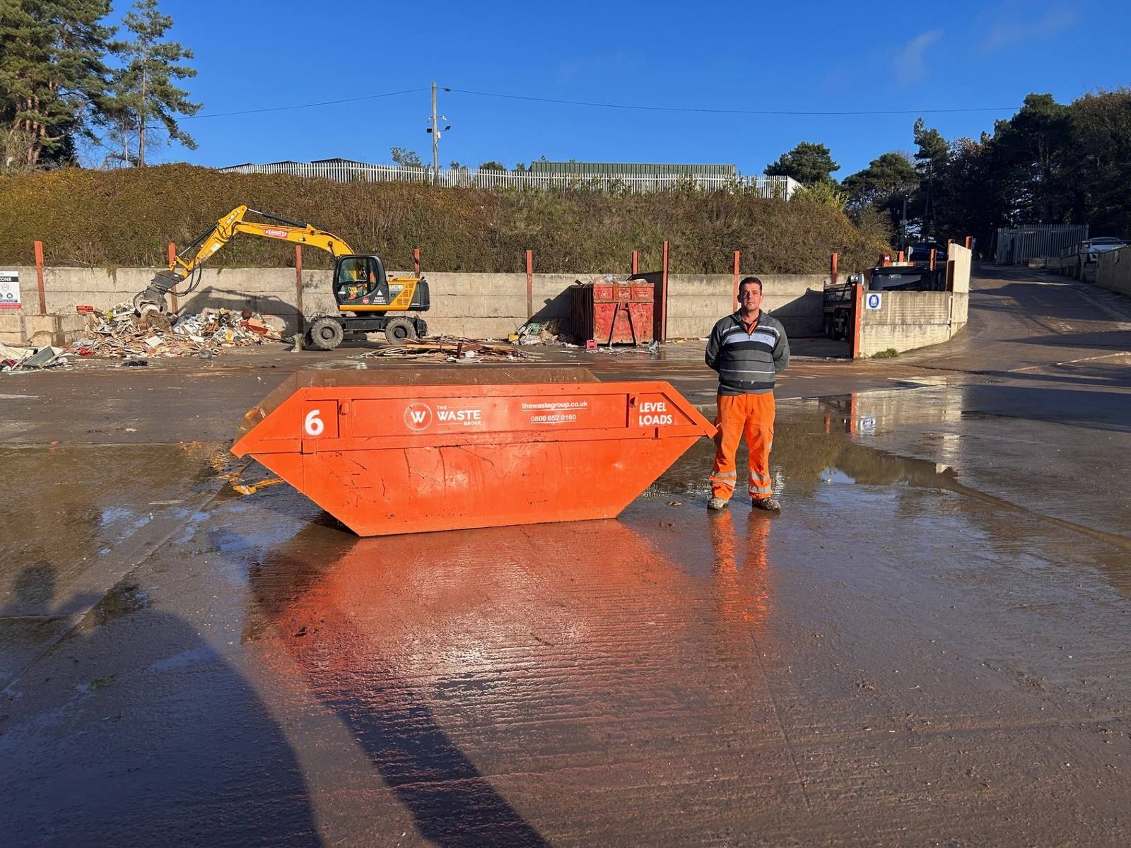 6 yard skip with a person standing beside it for scale at The Waste Group