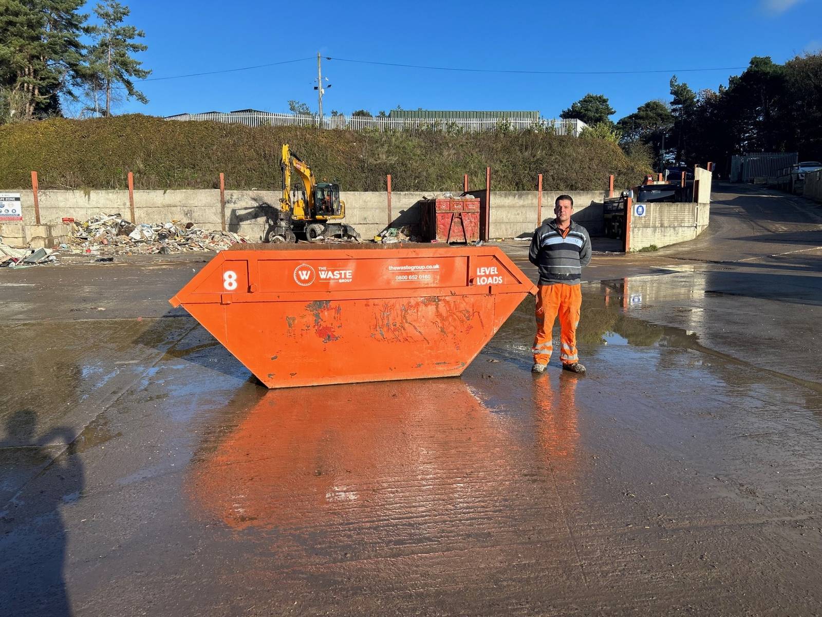 8 yard skip with a person standing beside it for scale at The Waste Group