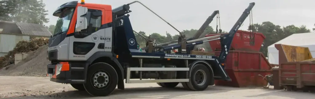 Dorset Skip Index: a Waste Group skip lorry delivering a skip at the start of a Dorset building job